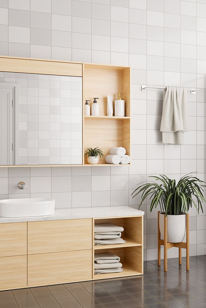 Modern bathroom with light wood cabinets, white sink, and tiled walls. Modern bathroom with light wood cabinets, white sink, and tiled walls.