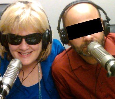 Black microphone with pop filter on a stand, isolated on white.