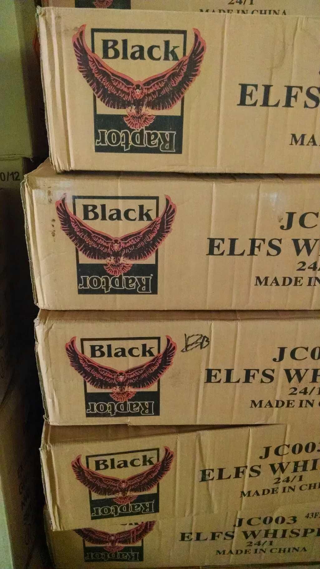 A stack of boxes of black elf 's whiskey are sitting on top of each other.