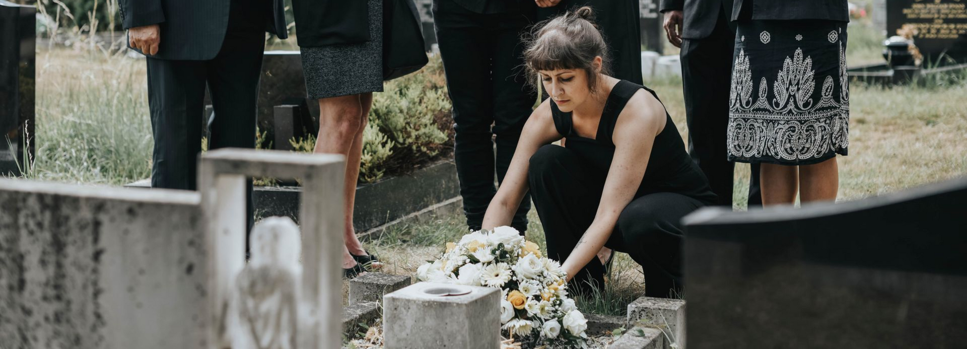 family at a tombstone paying their tributes