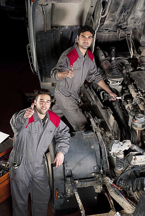 diesel repair mechanics giving thumbs up