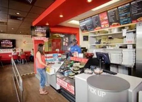 Eine Frau steht an der Theke eines Restaurants.