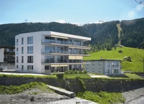 Ein großes weißes Gebäude steht auf einem Hügel mit Bergen im Hintergrund