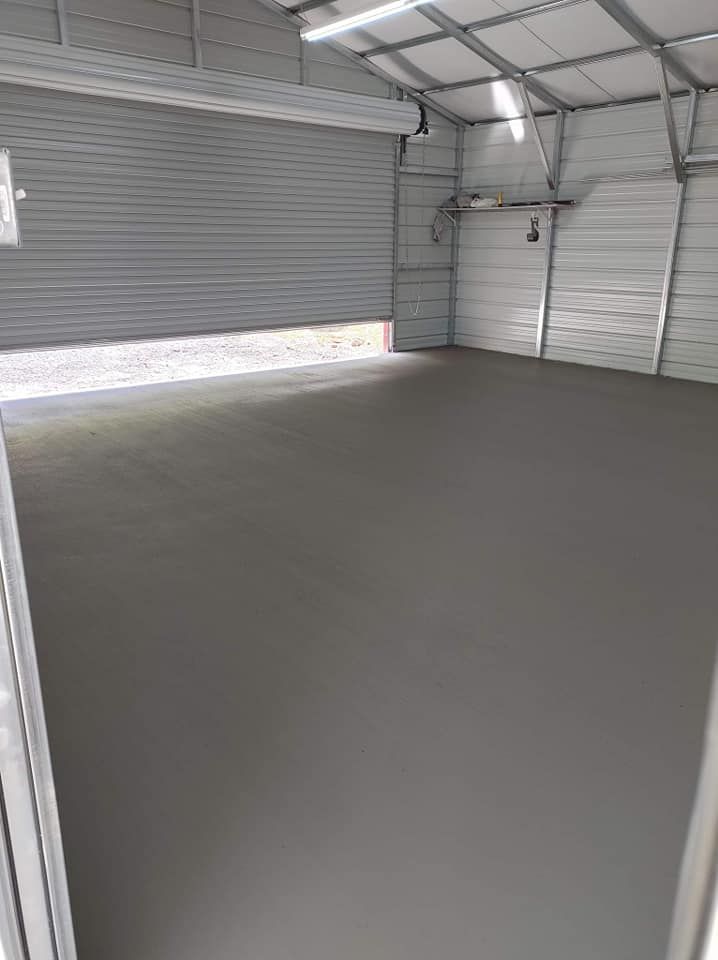 A garage with a concrete floor and a garage door.