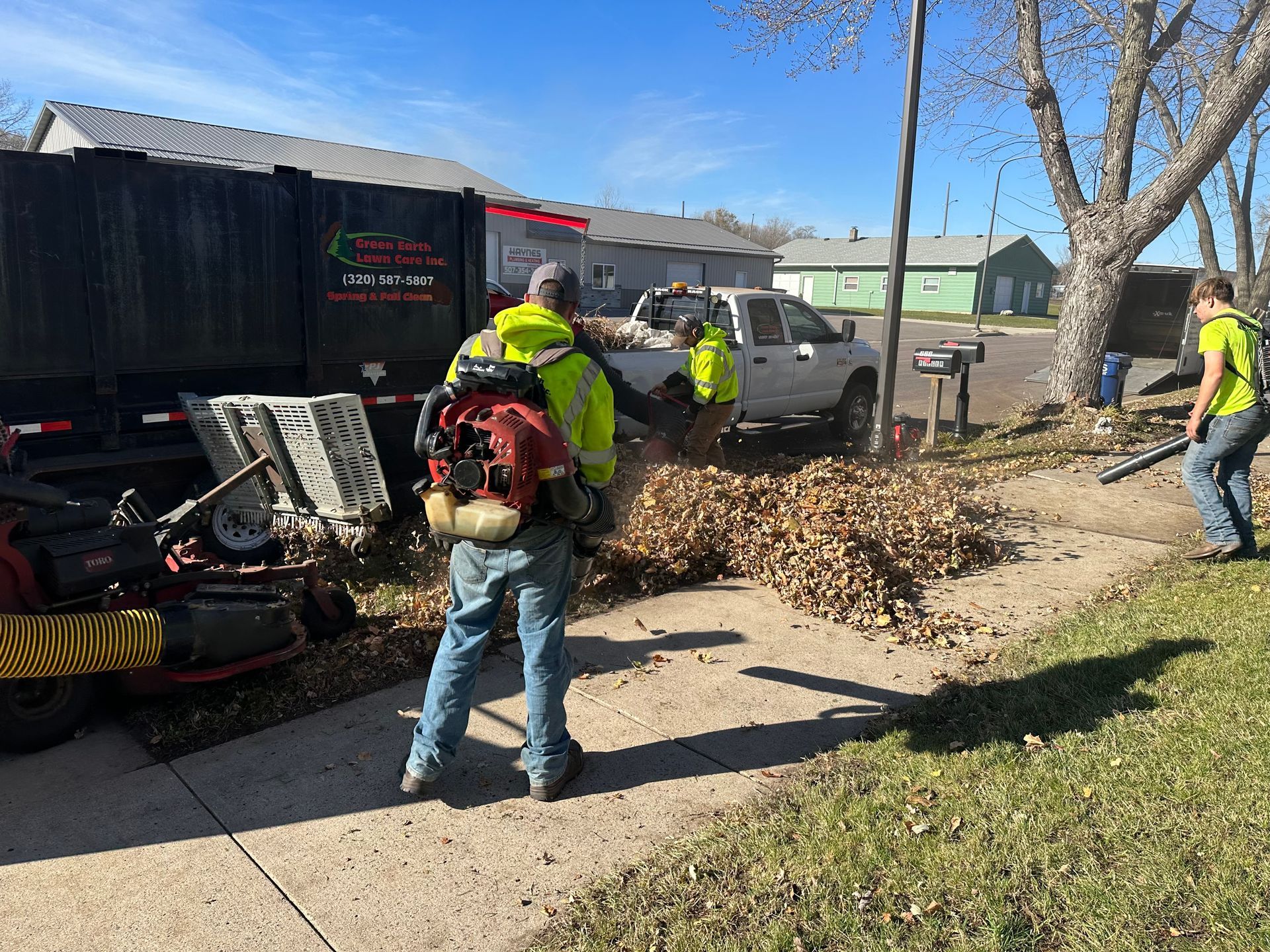 Workers Using Leaf Blower — Hutchinson, MN — Green Earth Lawn Care