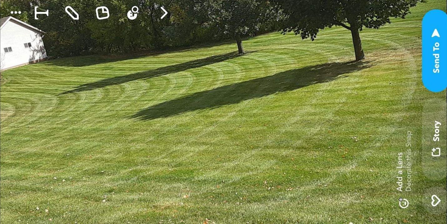 Man Applying Fertilizer — Hutchinson, MN — Green Earth Lawn Care