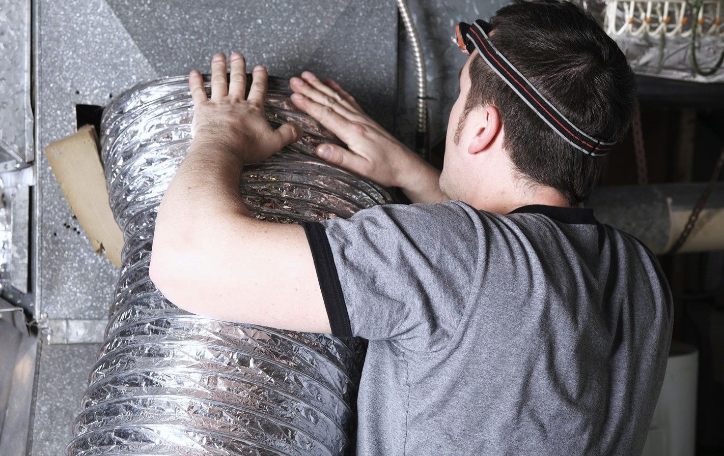 Skilled technician cleaning ducts for better air quality.