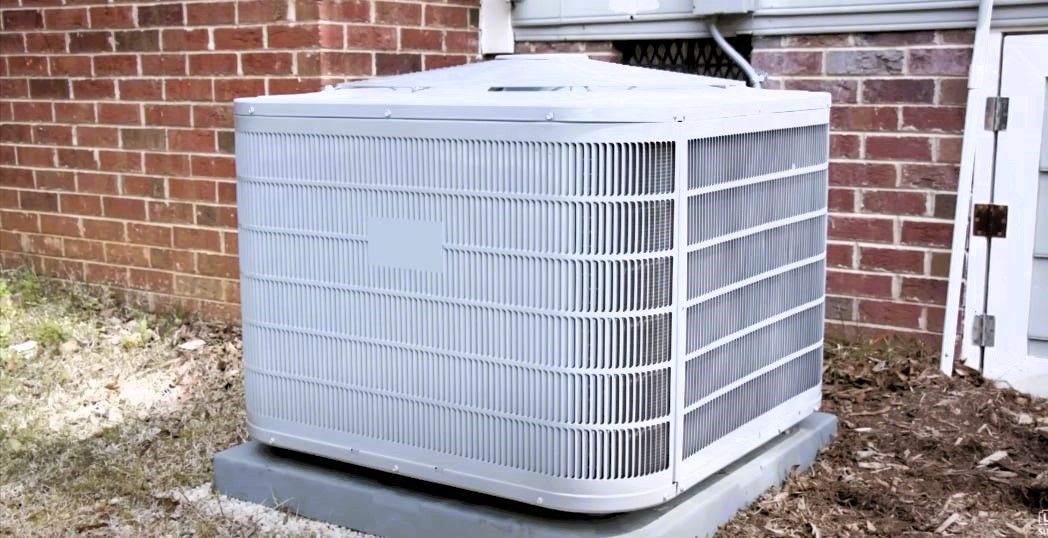 A residential central air conditioning unit located outside the house