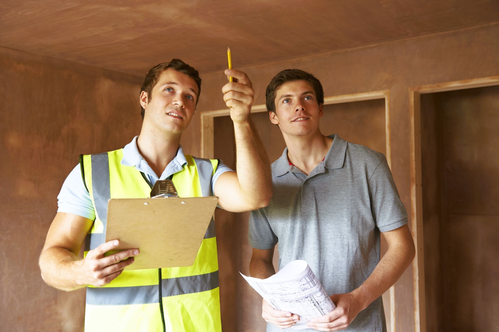 Professional and homeowner inspecting new home