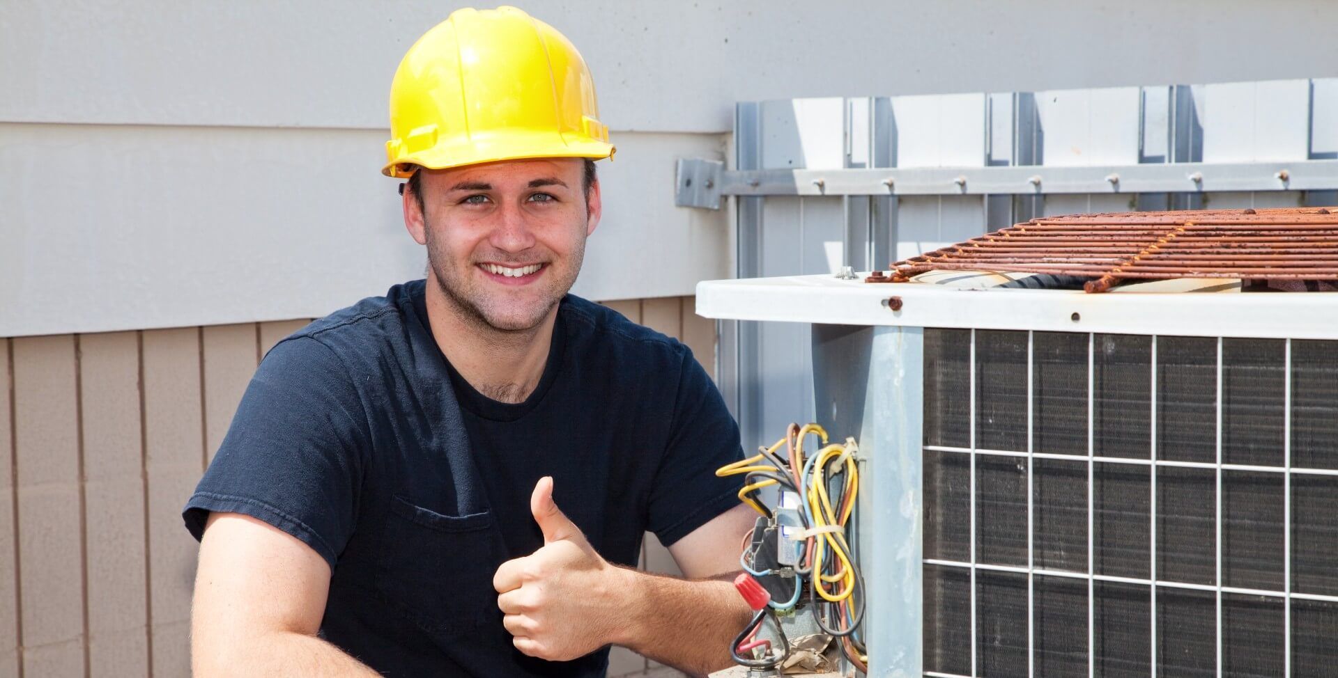 Air duct cleaner giving a thumbs up while conducting an air duct cleaning