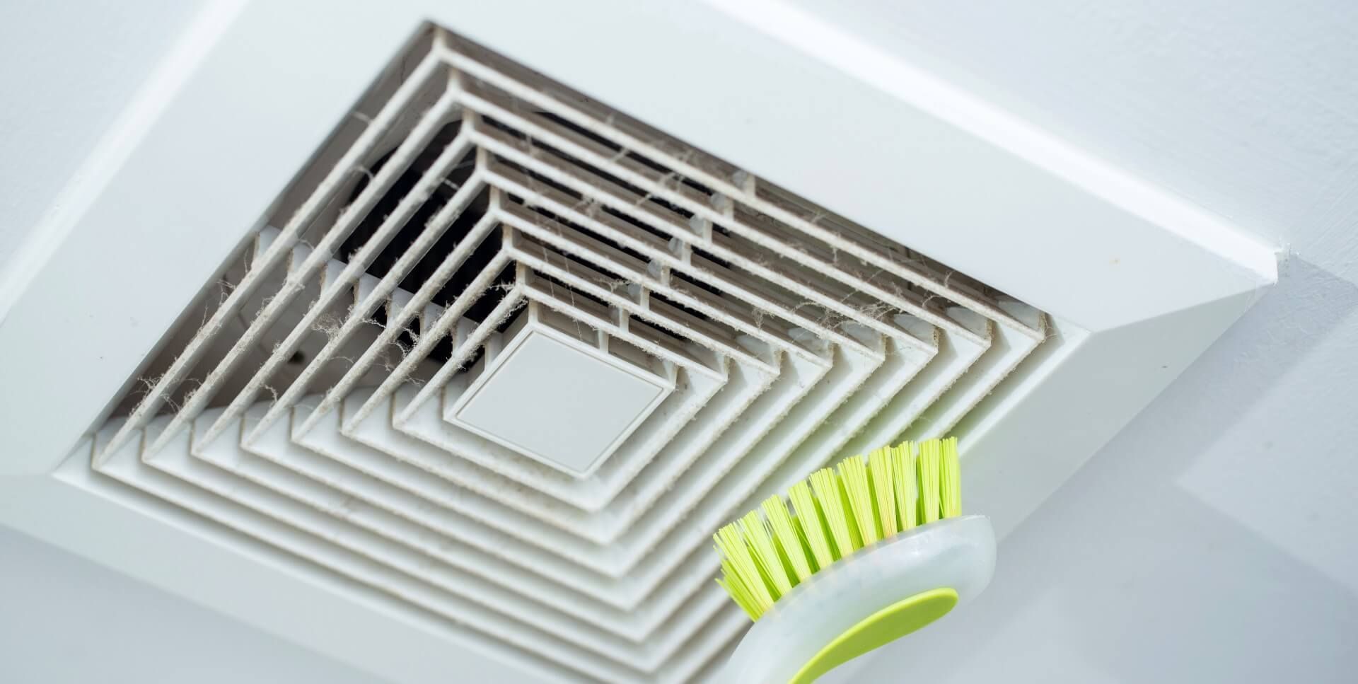 An air duct cleaner brushing the dust from an air vent