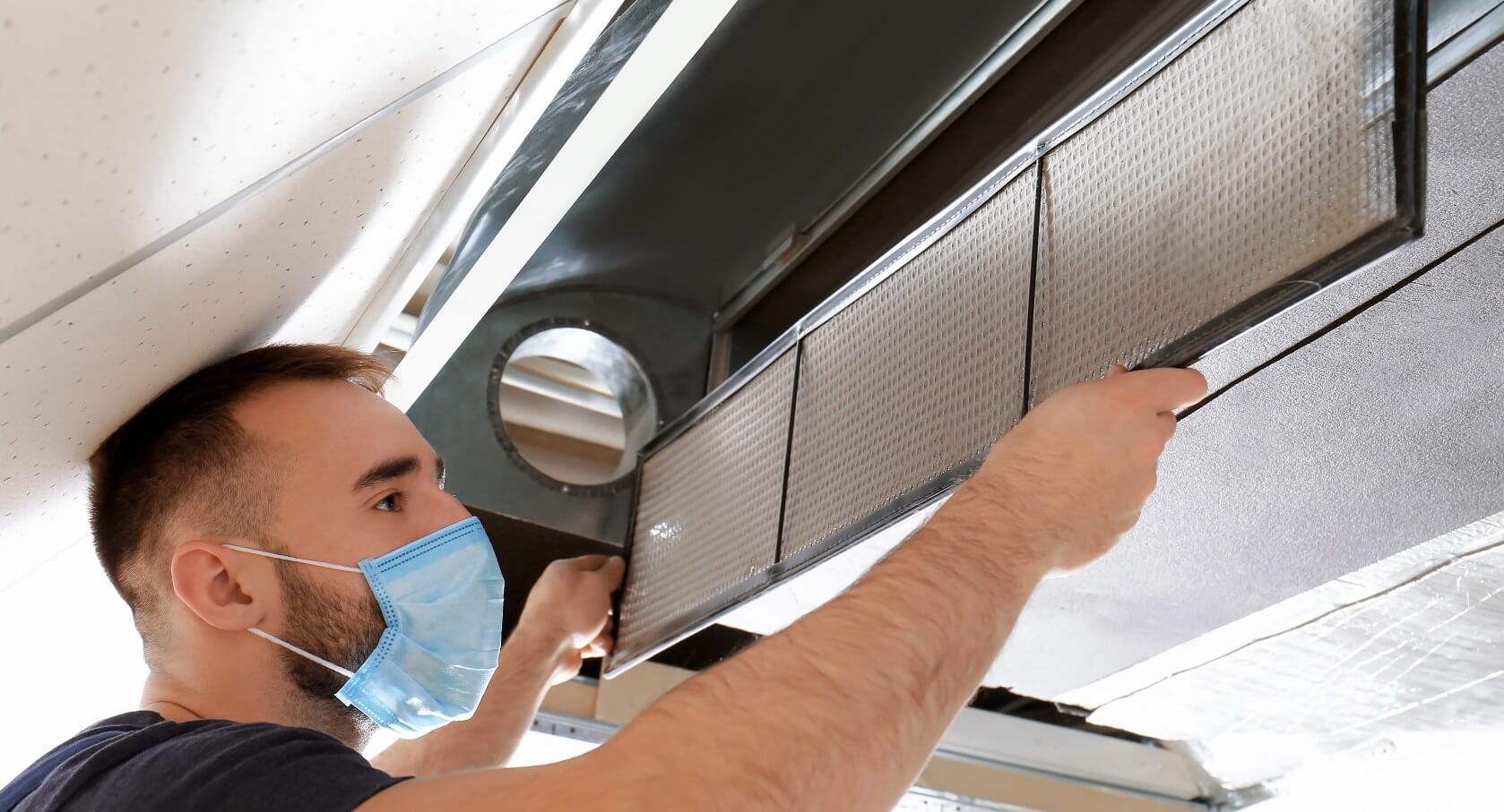 A man cleaning and sanitizing the air ducts