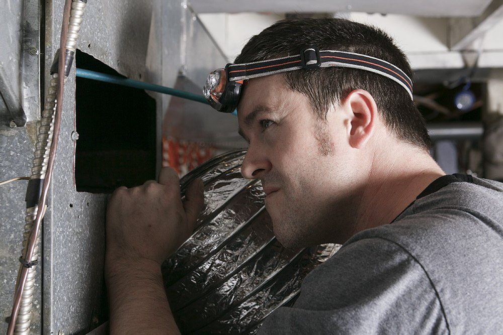 duct professional inspecting duct work