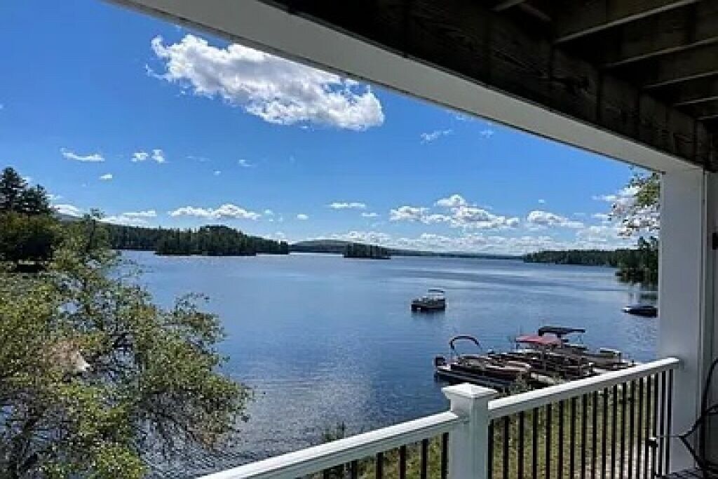 A view of a lake from a balcony on a sunny day.