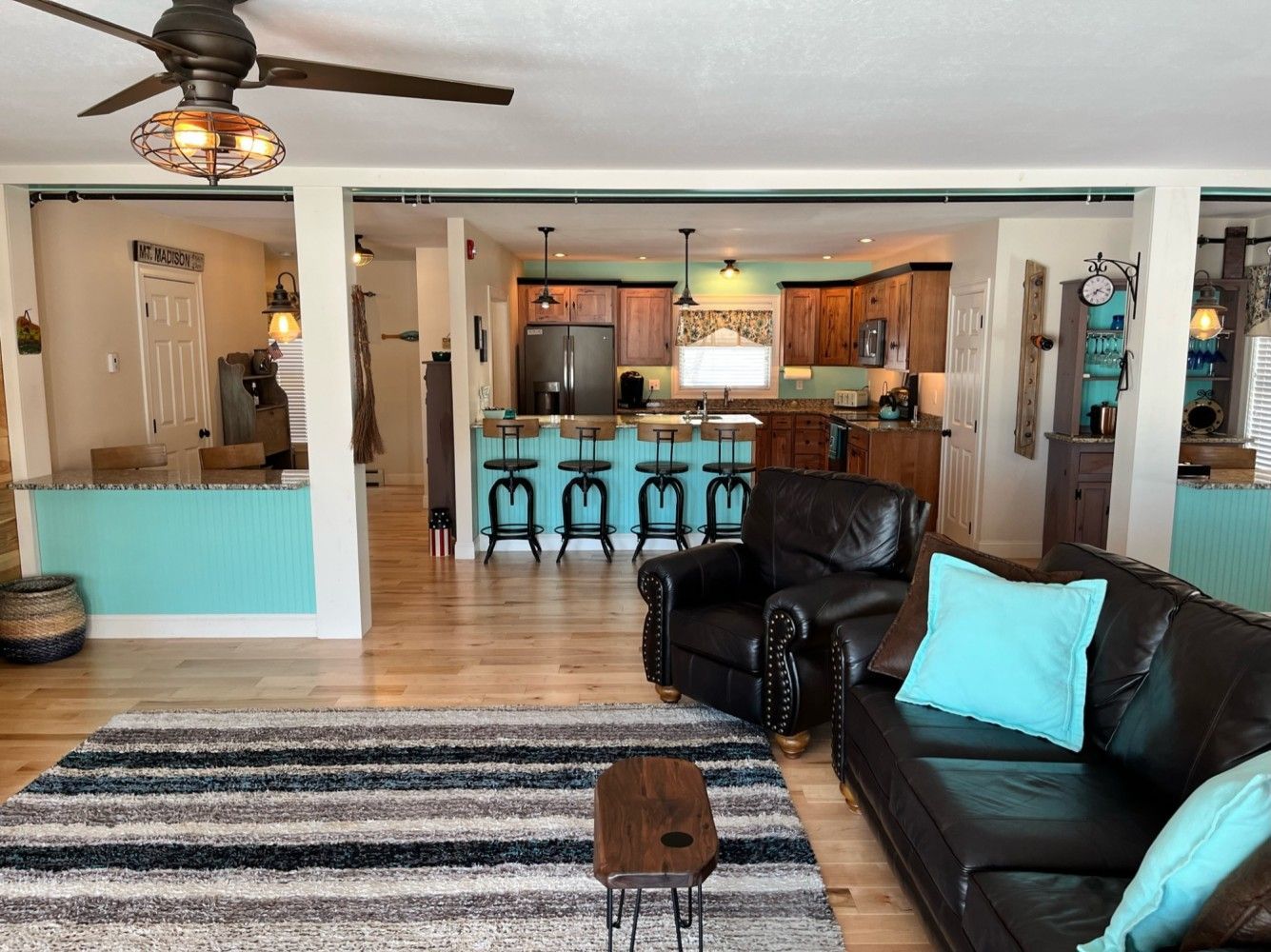 A living room filled with furniture and a ceiling fan.