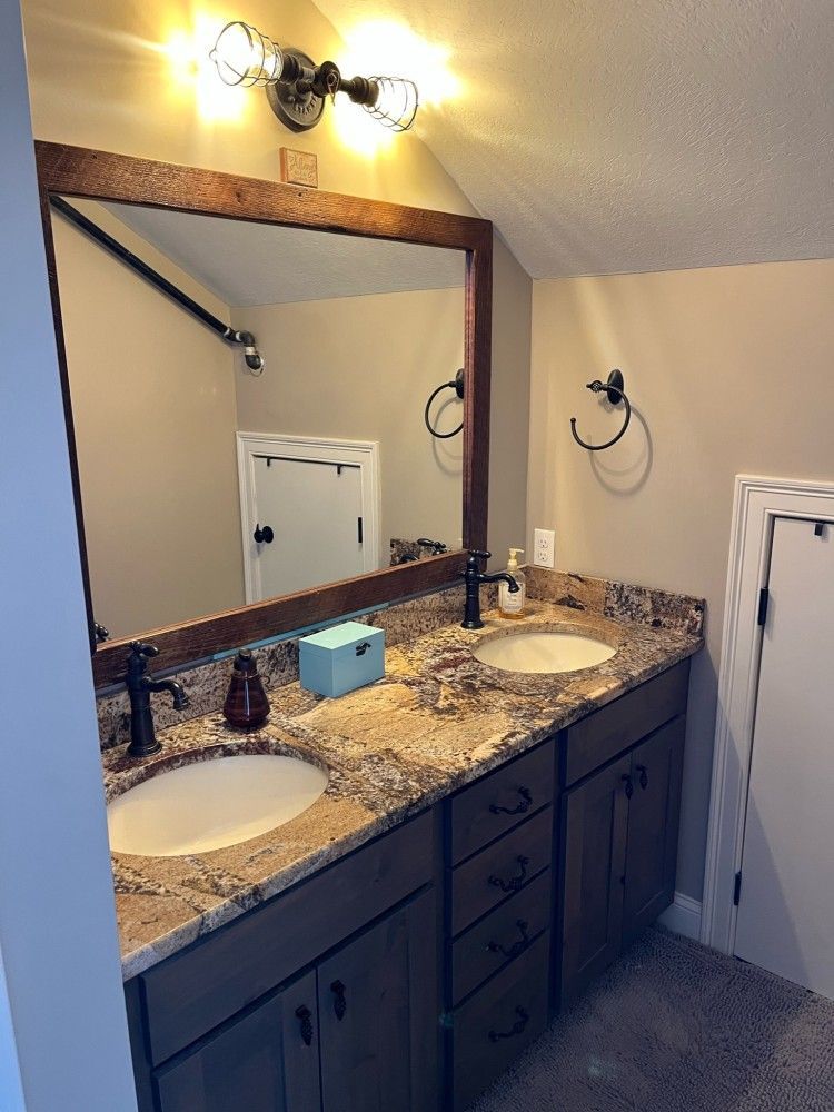 A bathroom with two sinks and a large mirror