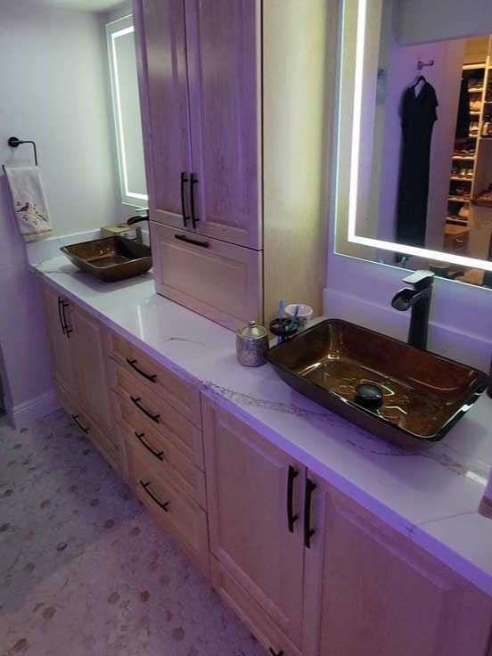 A bathroom with two sinks and a mirror.