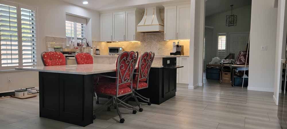 A kitchen with a table and chairs in it.