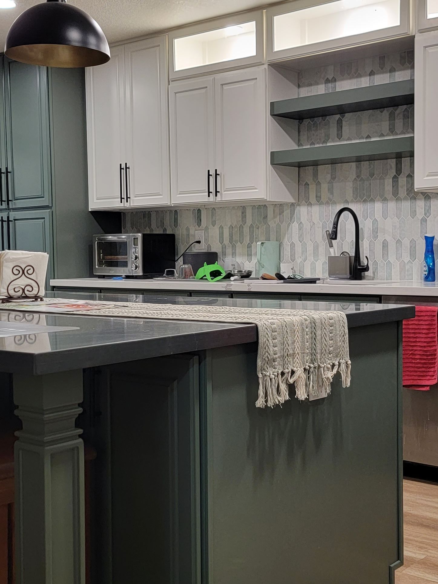 A kitchen with a large island and a sink.