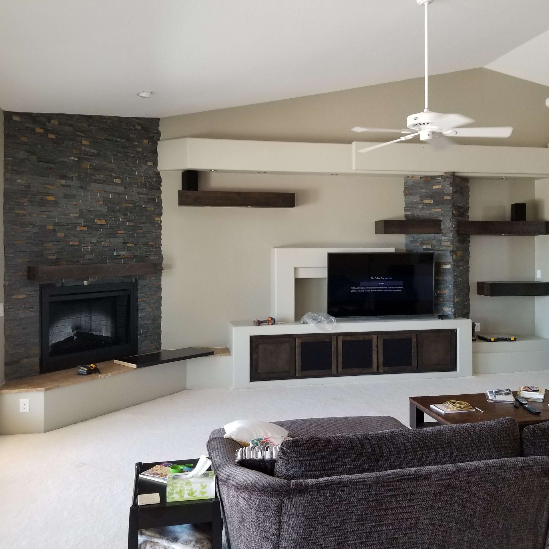 A living room with a fireplace and a flat screen TV.