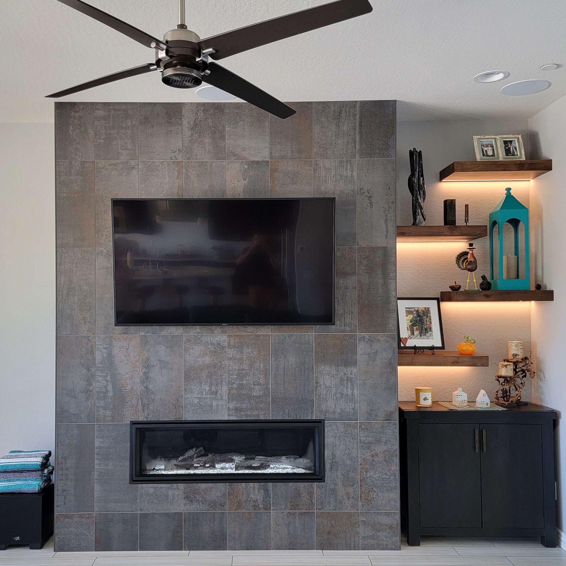 A living room with a fireplace and a flat screen TV.