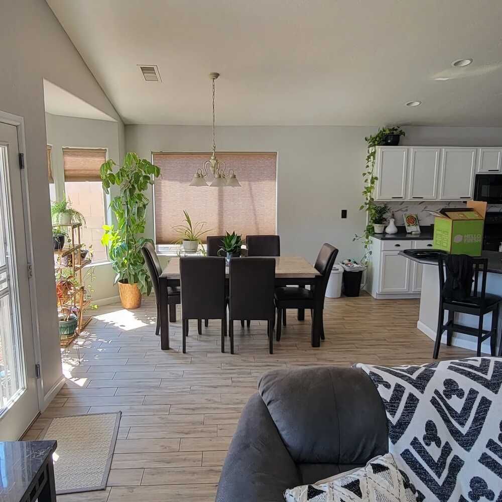 A living room with a dining room table and chairs
