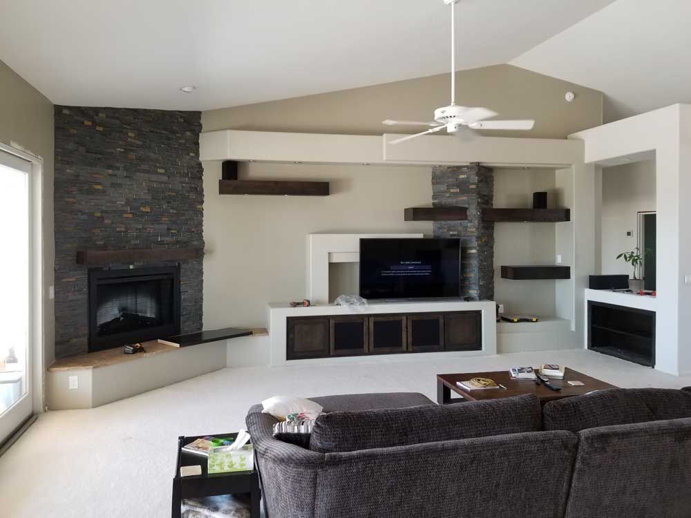 A living room with a fireplace and a flat screen tv