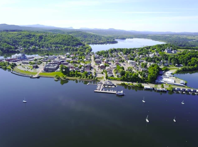 An aerial view of a small town on the shore of a lake.