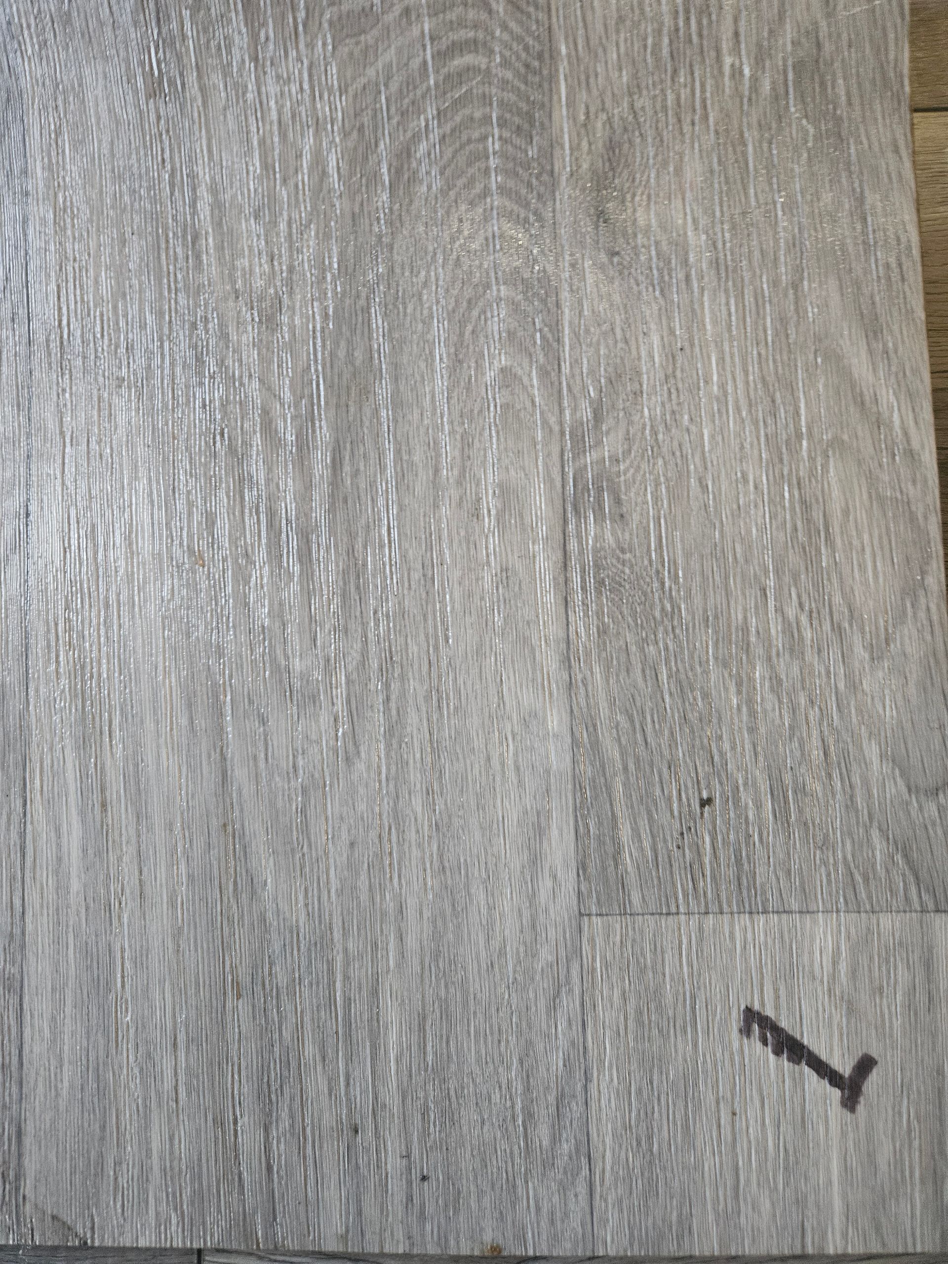 A close up of a piece of wood with a screw in it.