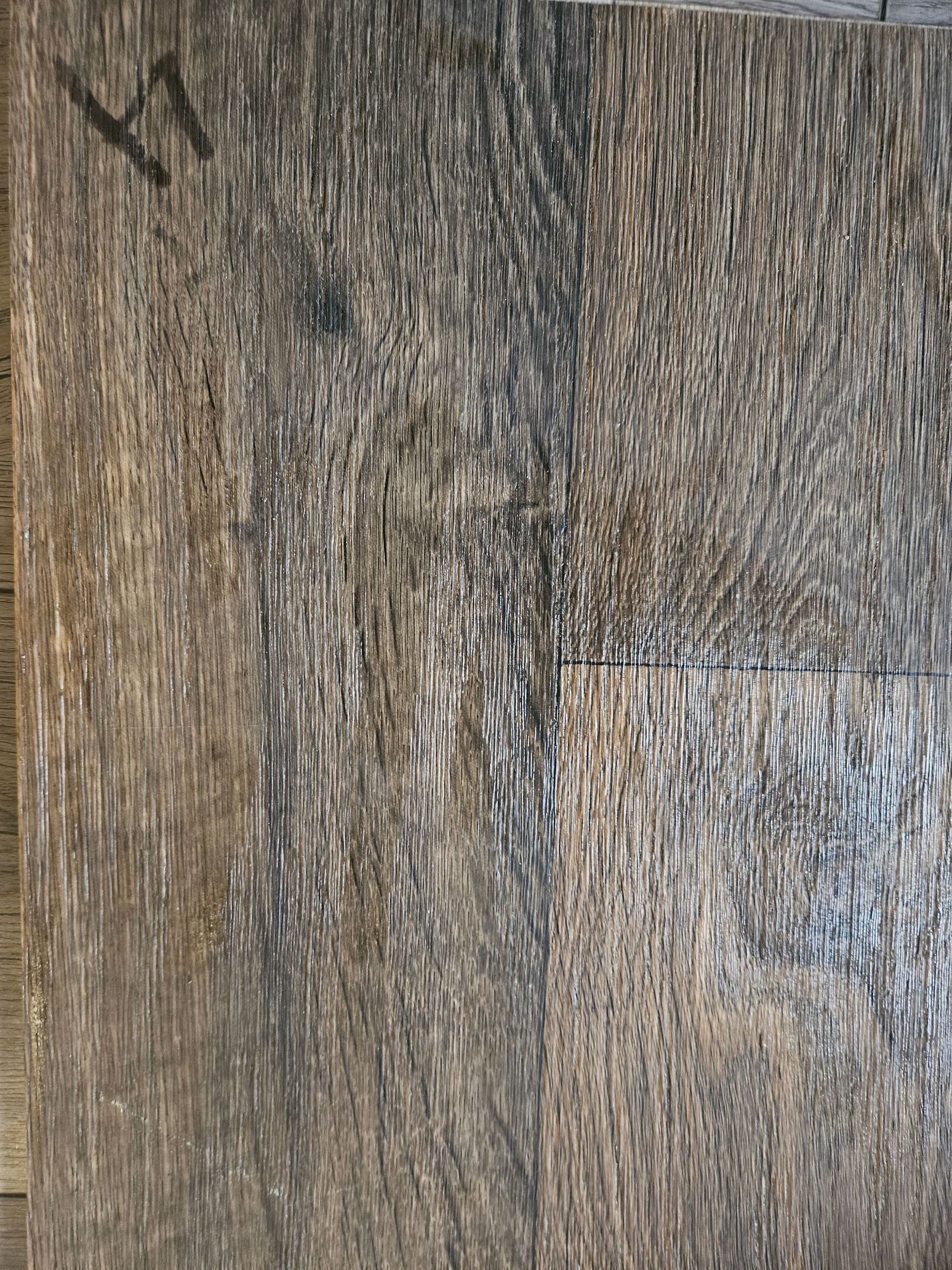 A close up of a piece of wood with a grainy texture.