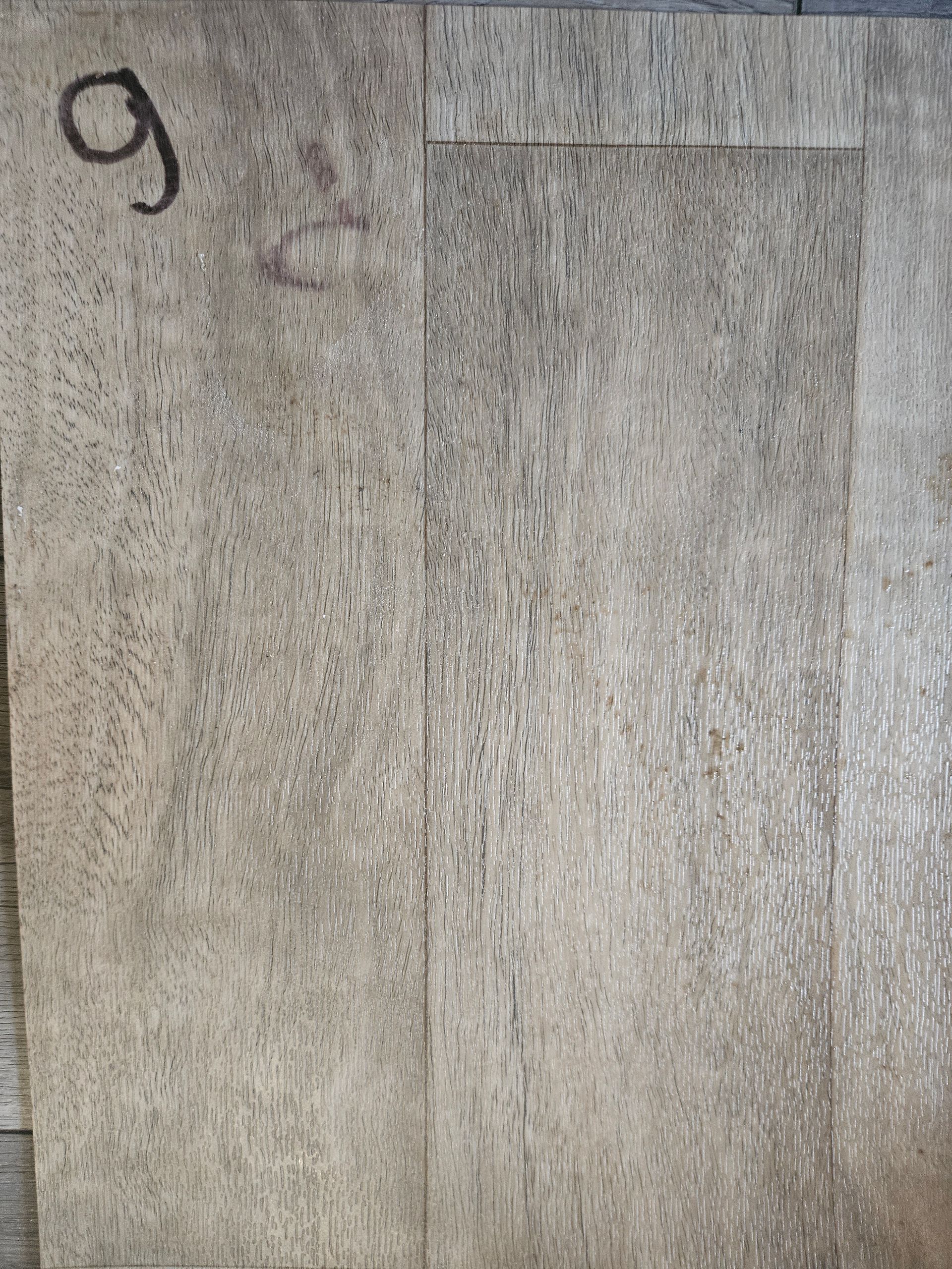 A piece of wood with the number 9 on it.