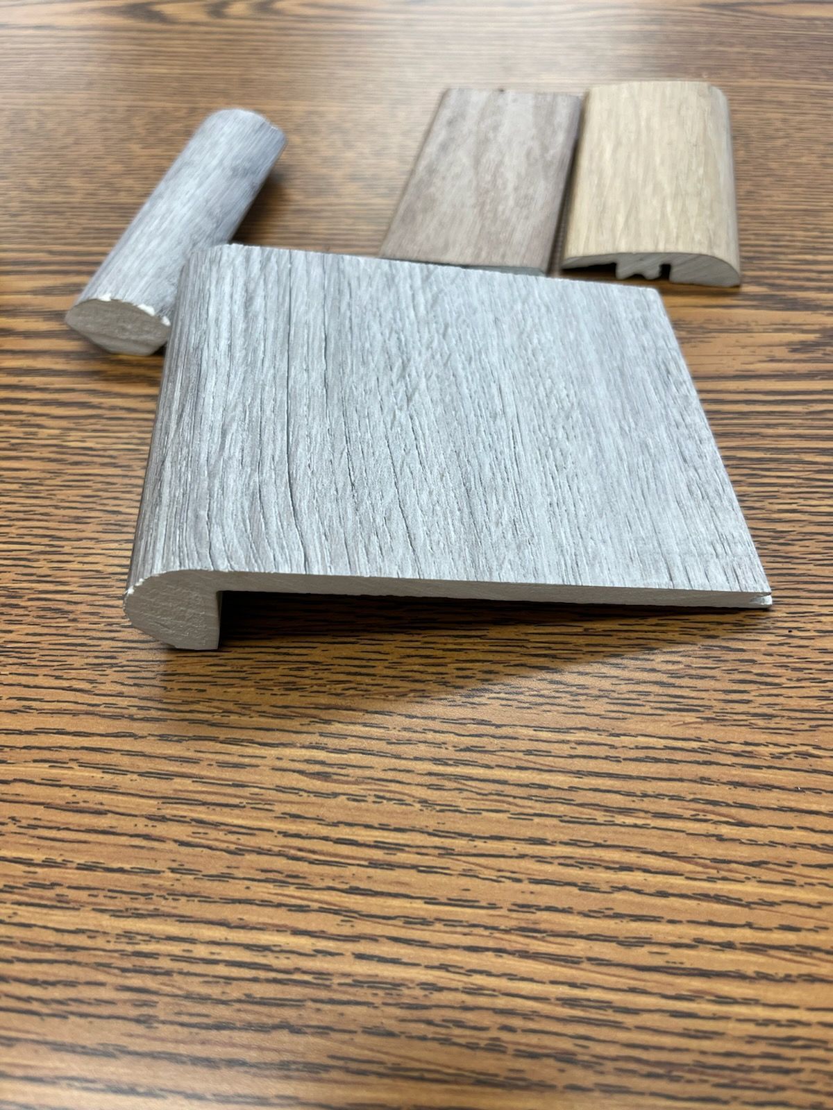 A piece of wood is sitting on top of a wooden table.