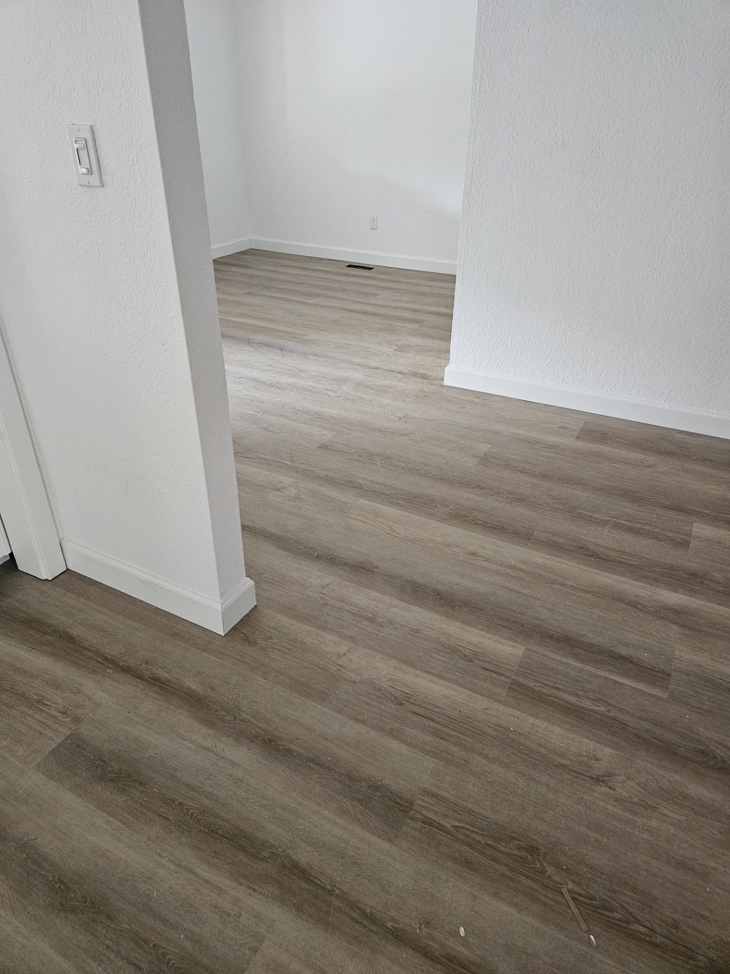 A room with a wooden floor and white walls.
