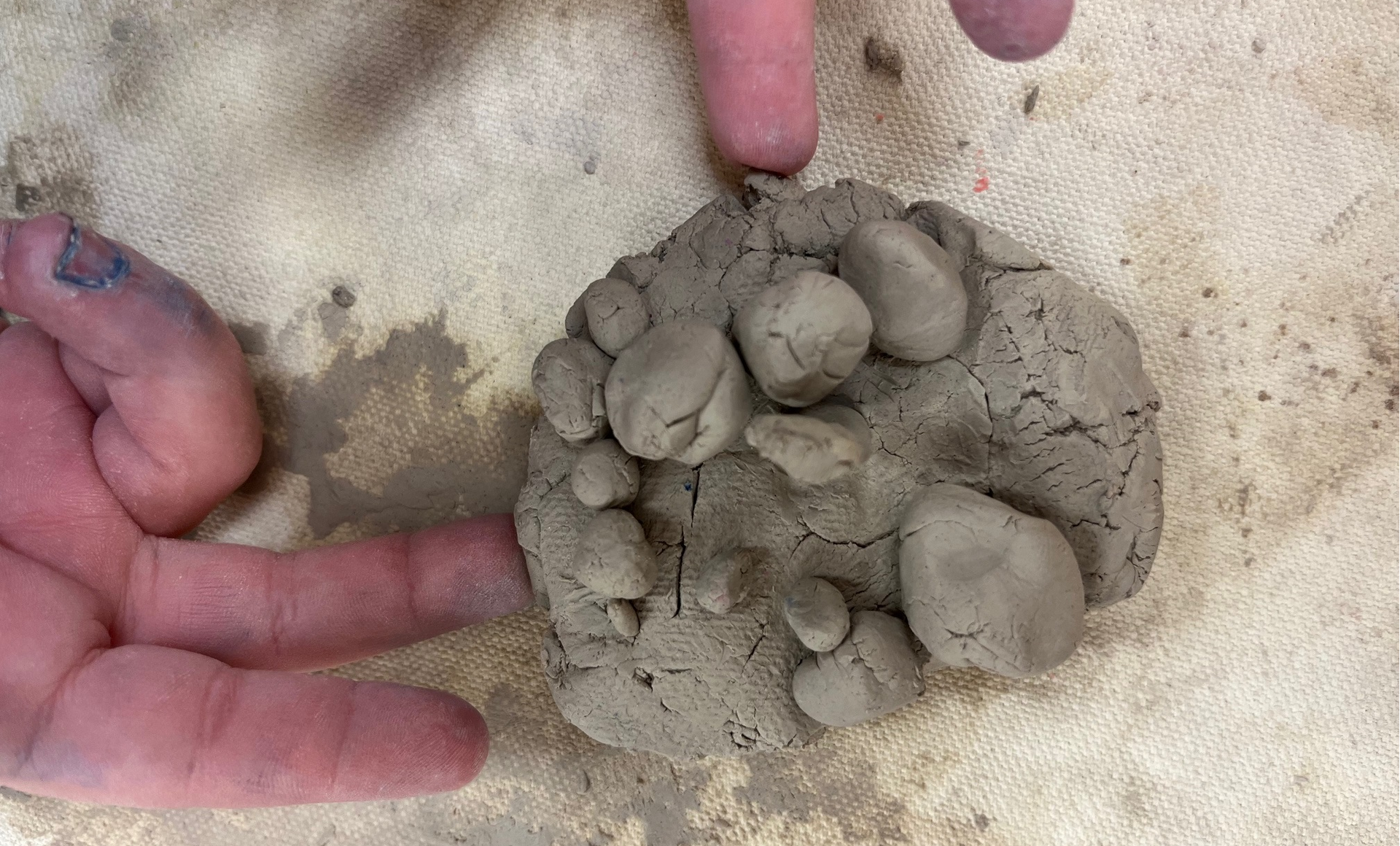 Photo of child's hand molding clay