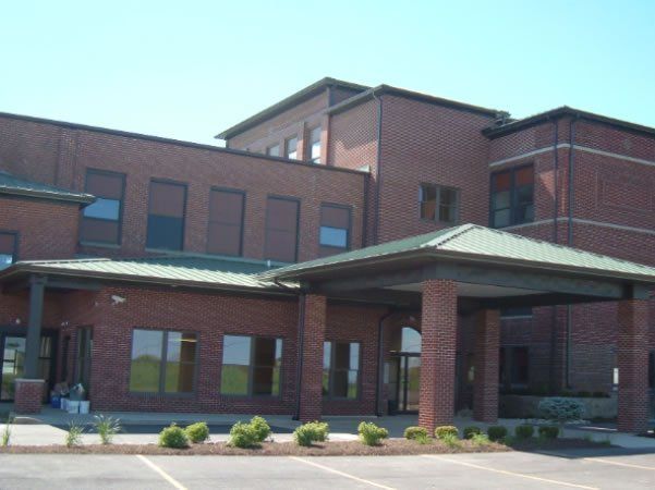 A large brick building with a green roof