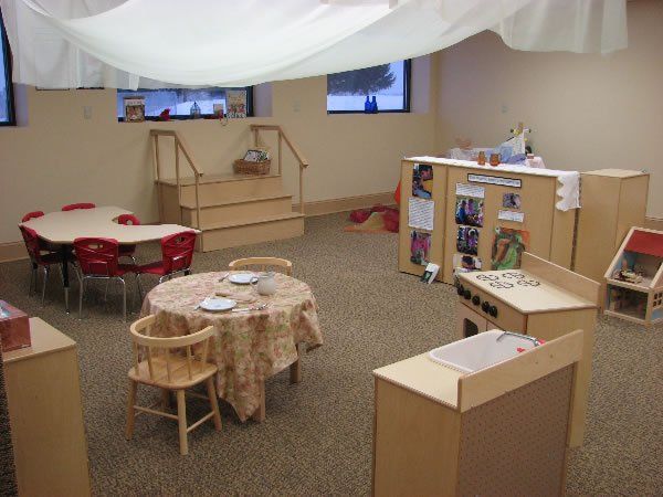 A room with tables and chairs and a white cloth hanging from the ceiling