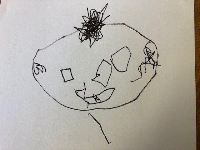 A child 's drawing of a face with a flower on top