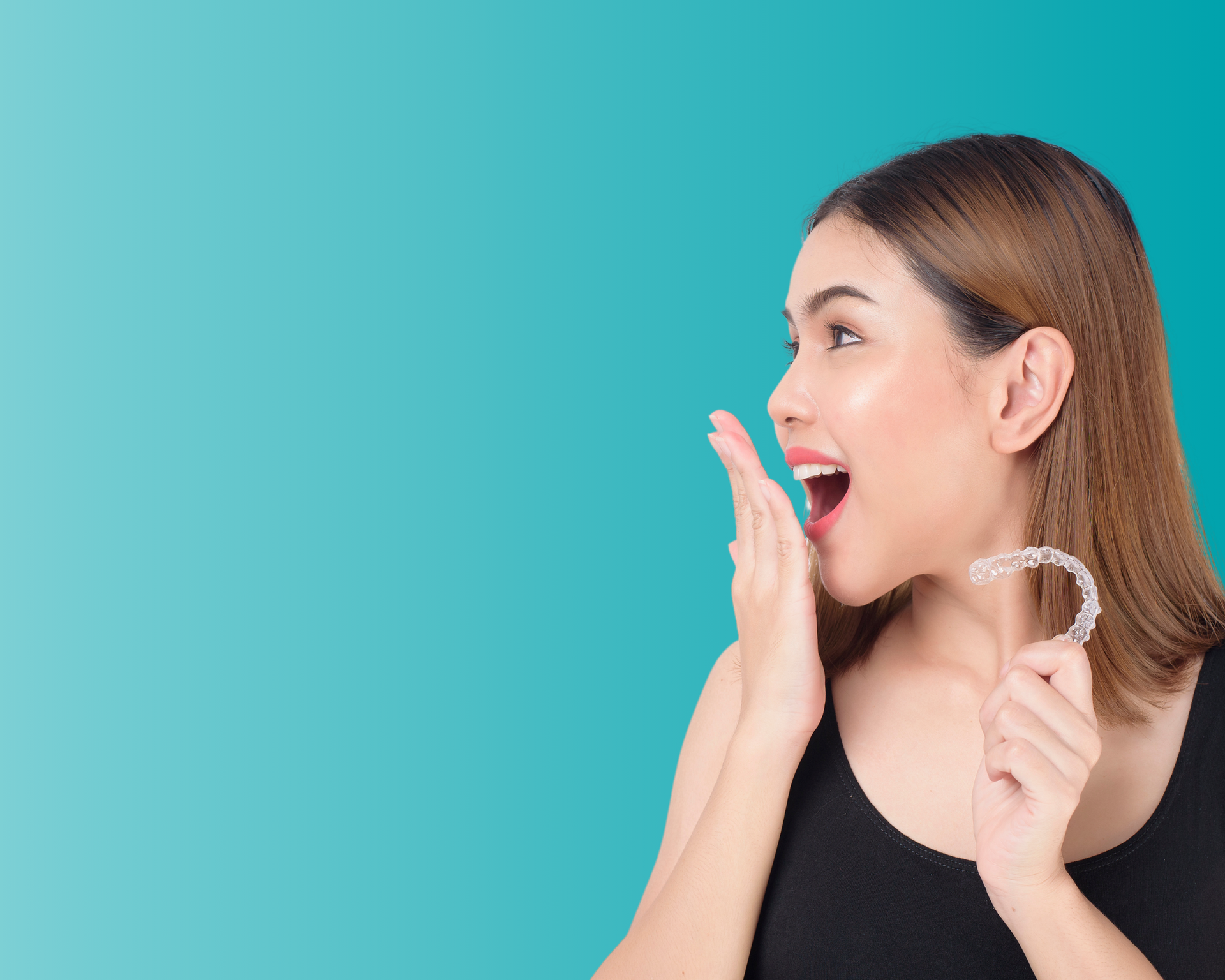 a woman is holding a clear brace in her hand .