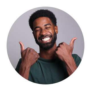 a man with a beard is smiling and giving two thumbs up