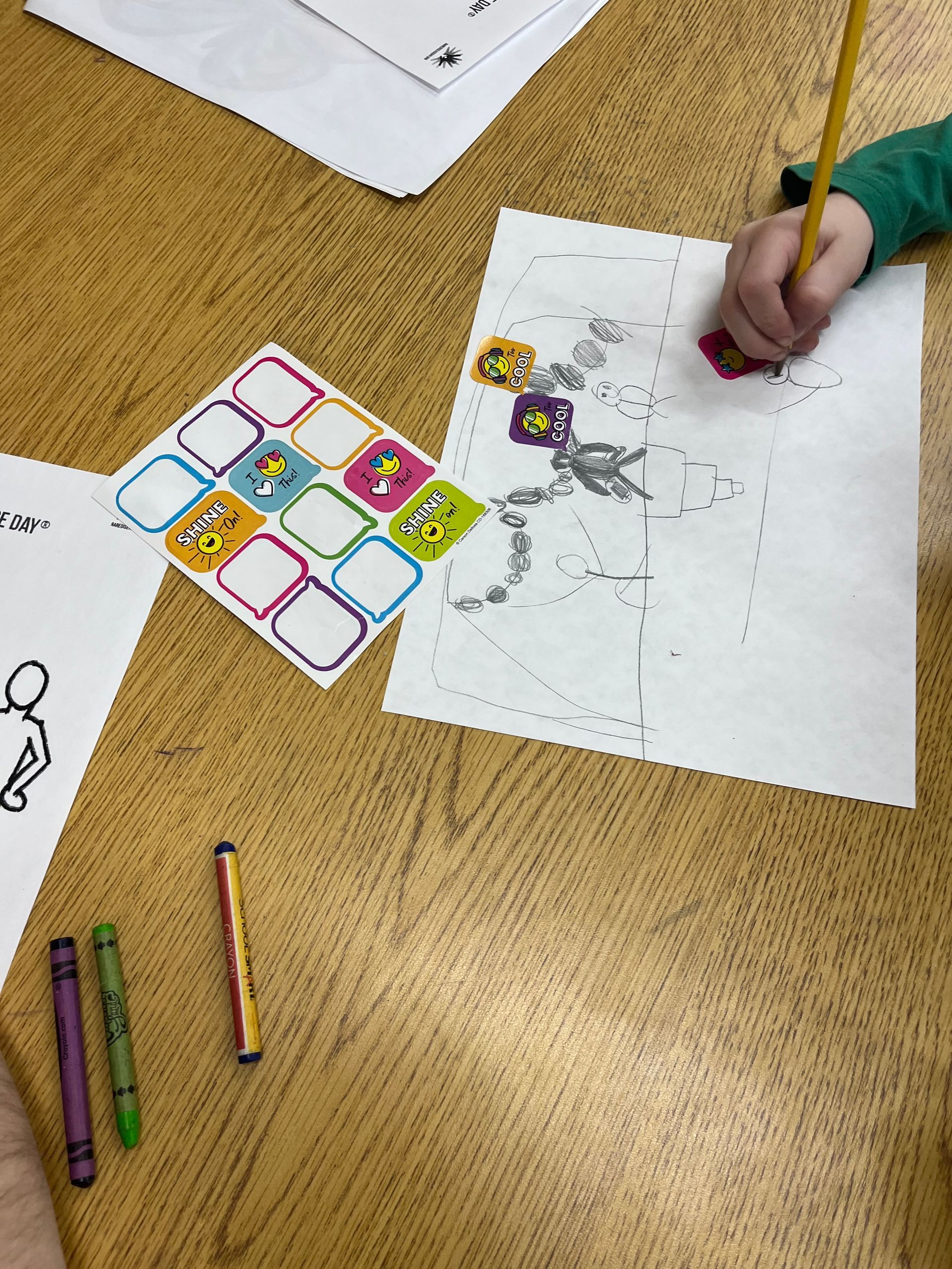 A child is drawing a picture of a skeleton on a piece of paper.