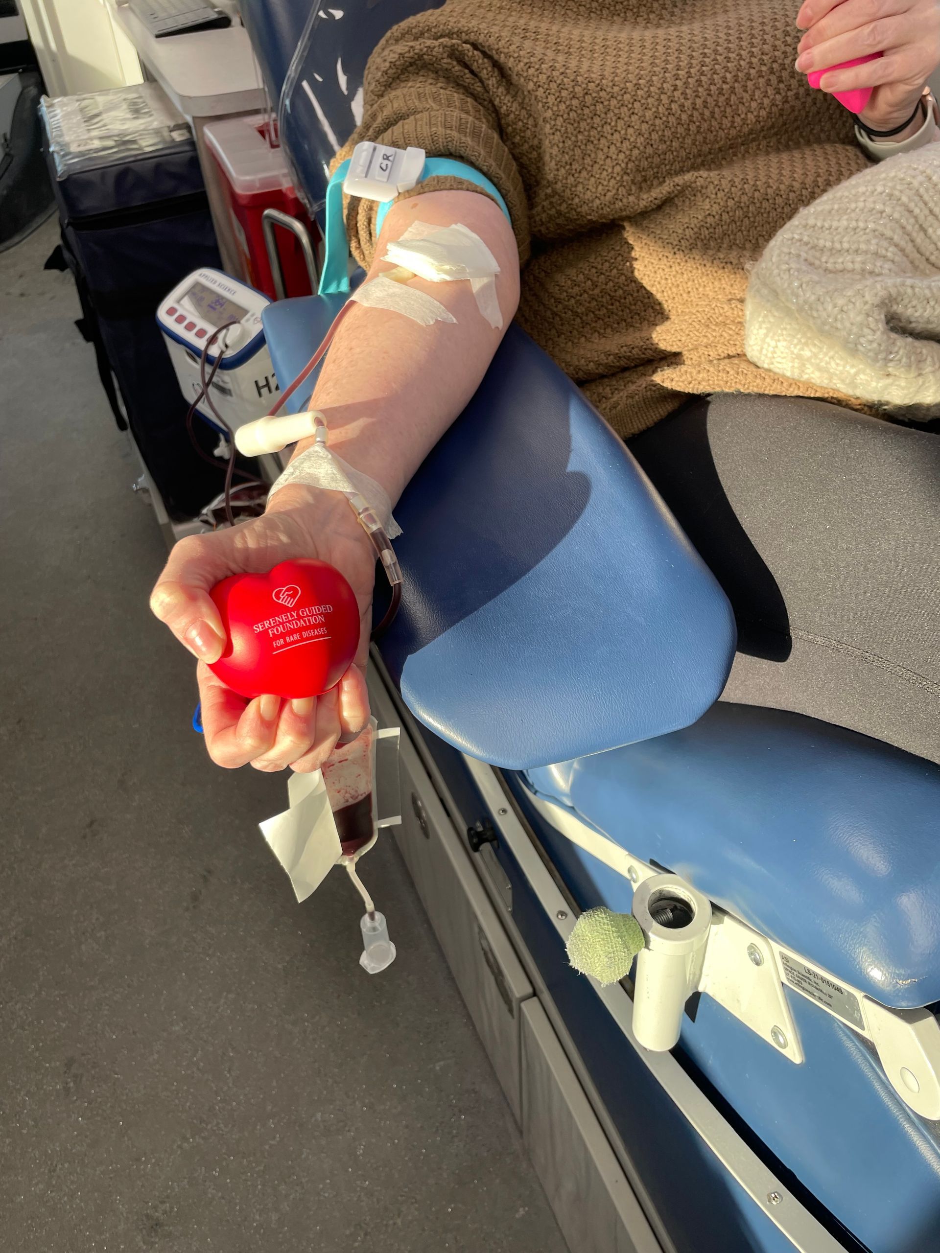 Serenely Guided Foundation Blood Drive and woman holding a stress ball.