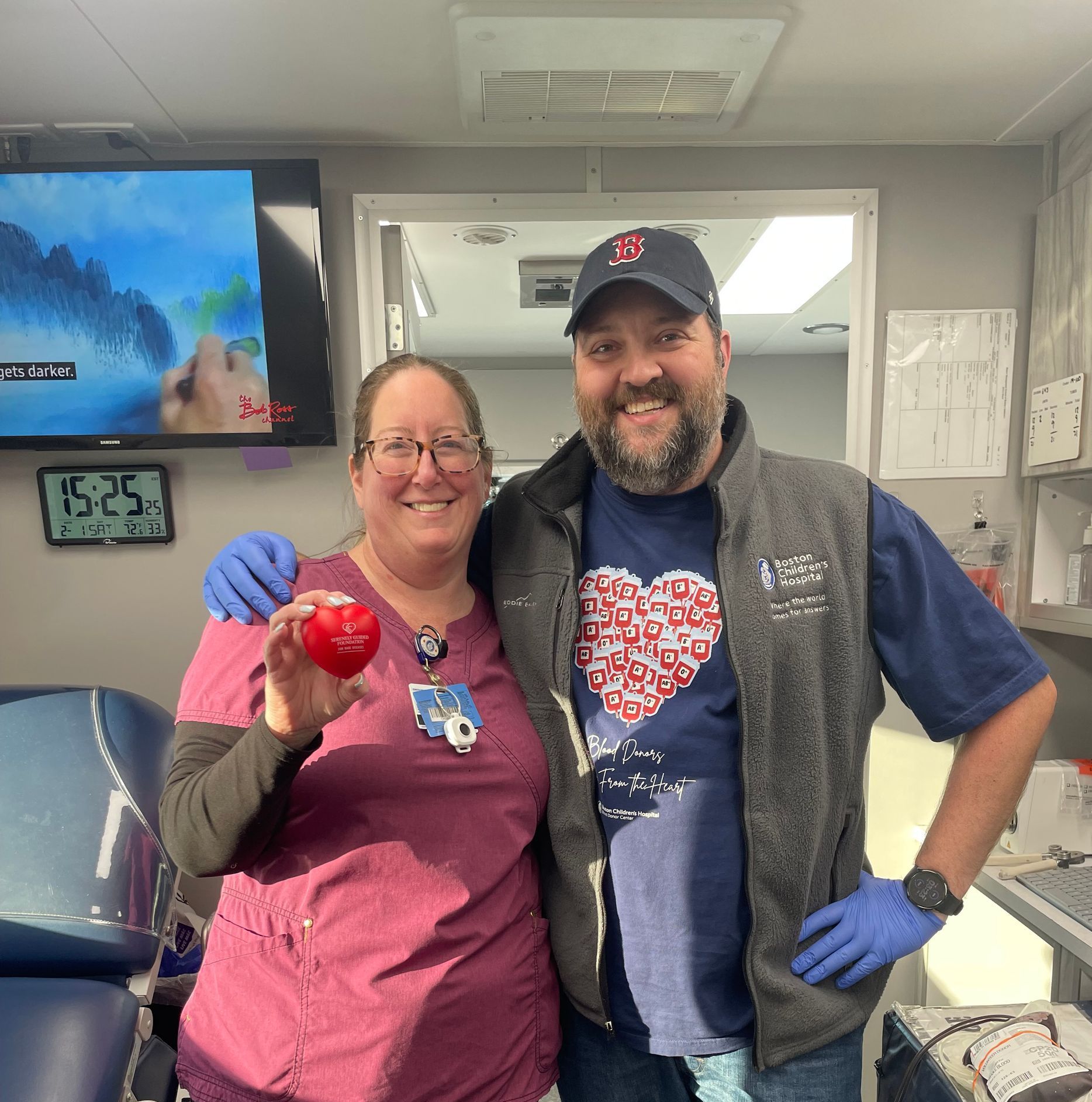 A man and a woman are posing for a picture in a room.