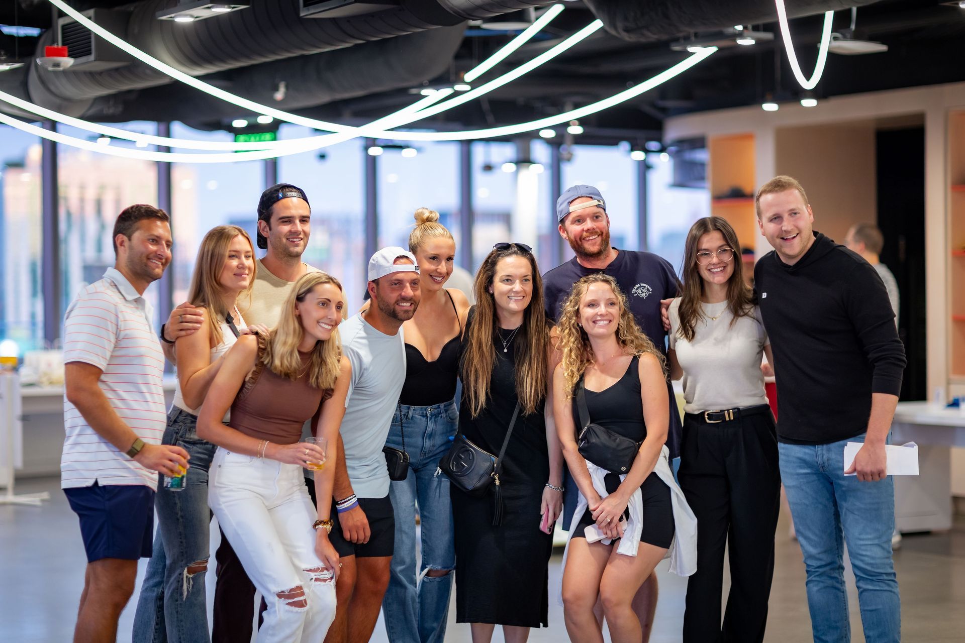 A group of people are posing for a picture together in a room.
