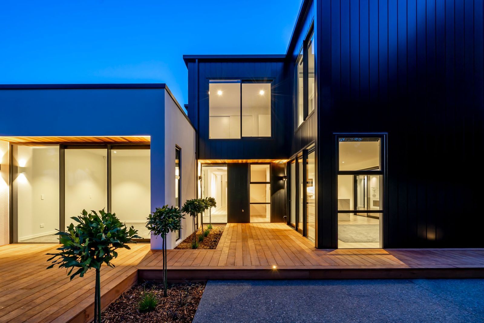 A house with a lot of windows and a wooden deck