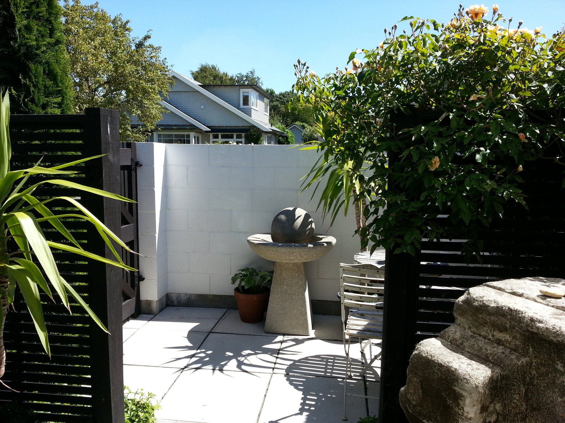 A patio with a fountain in the middle of it