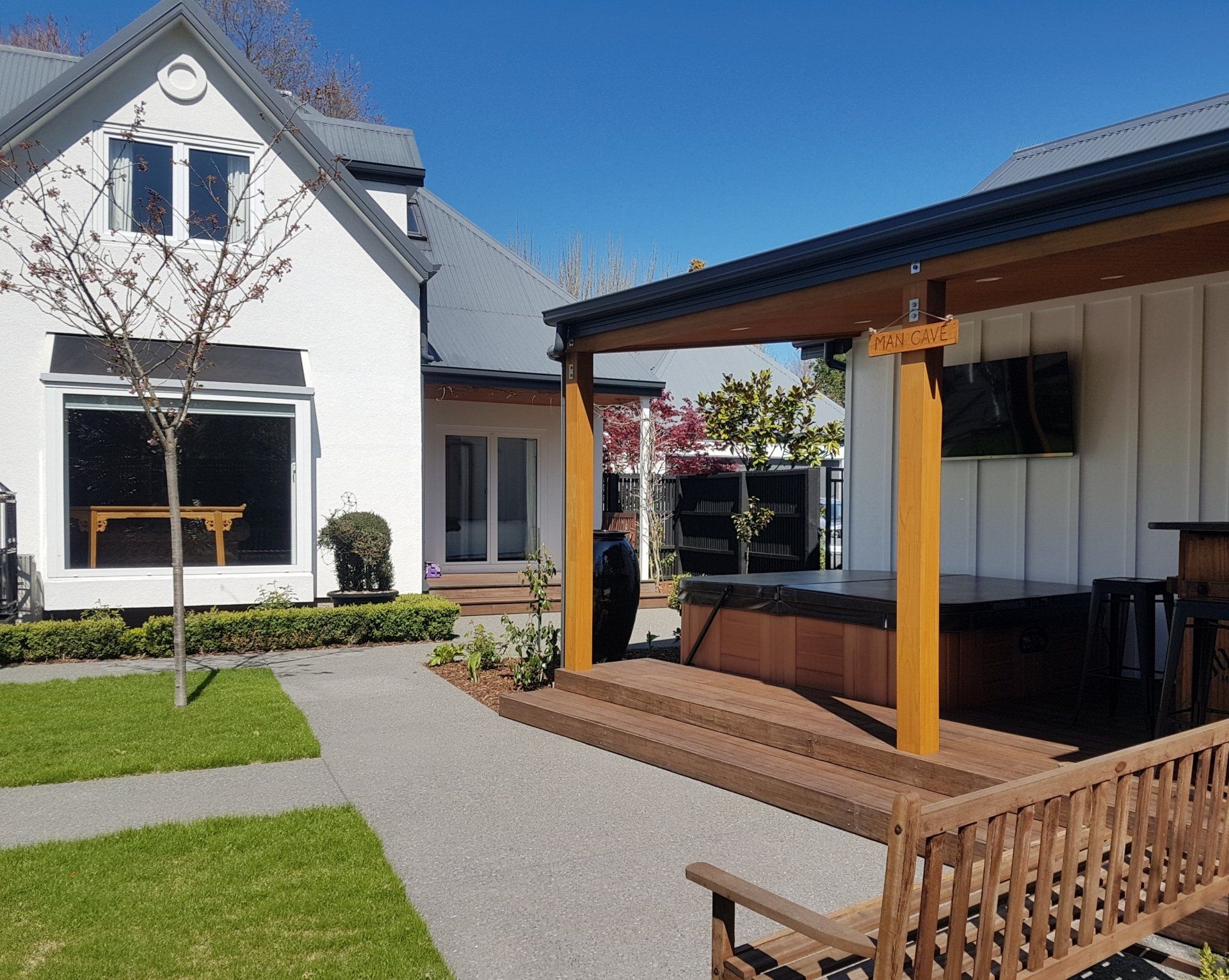 A white house with a wooden bench in front of it