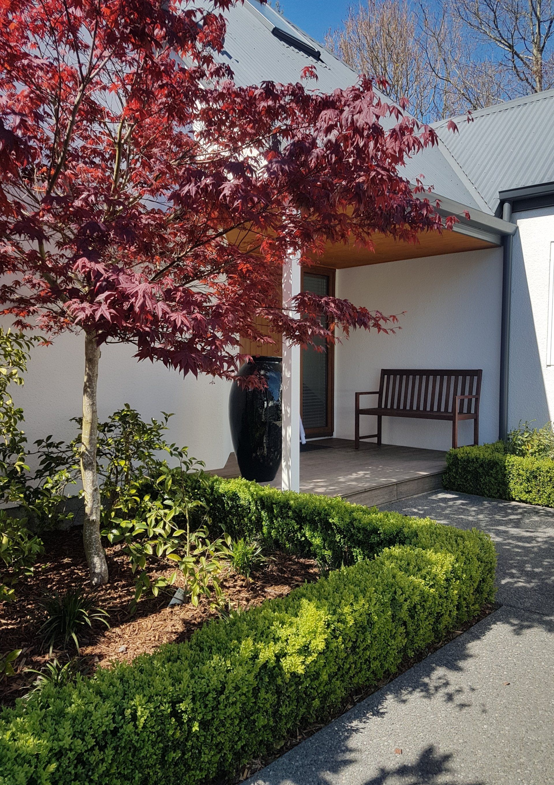 A white house with a bench in front of it
