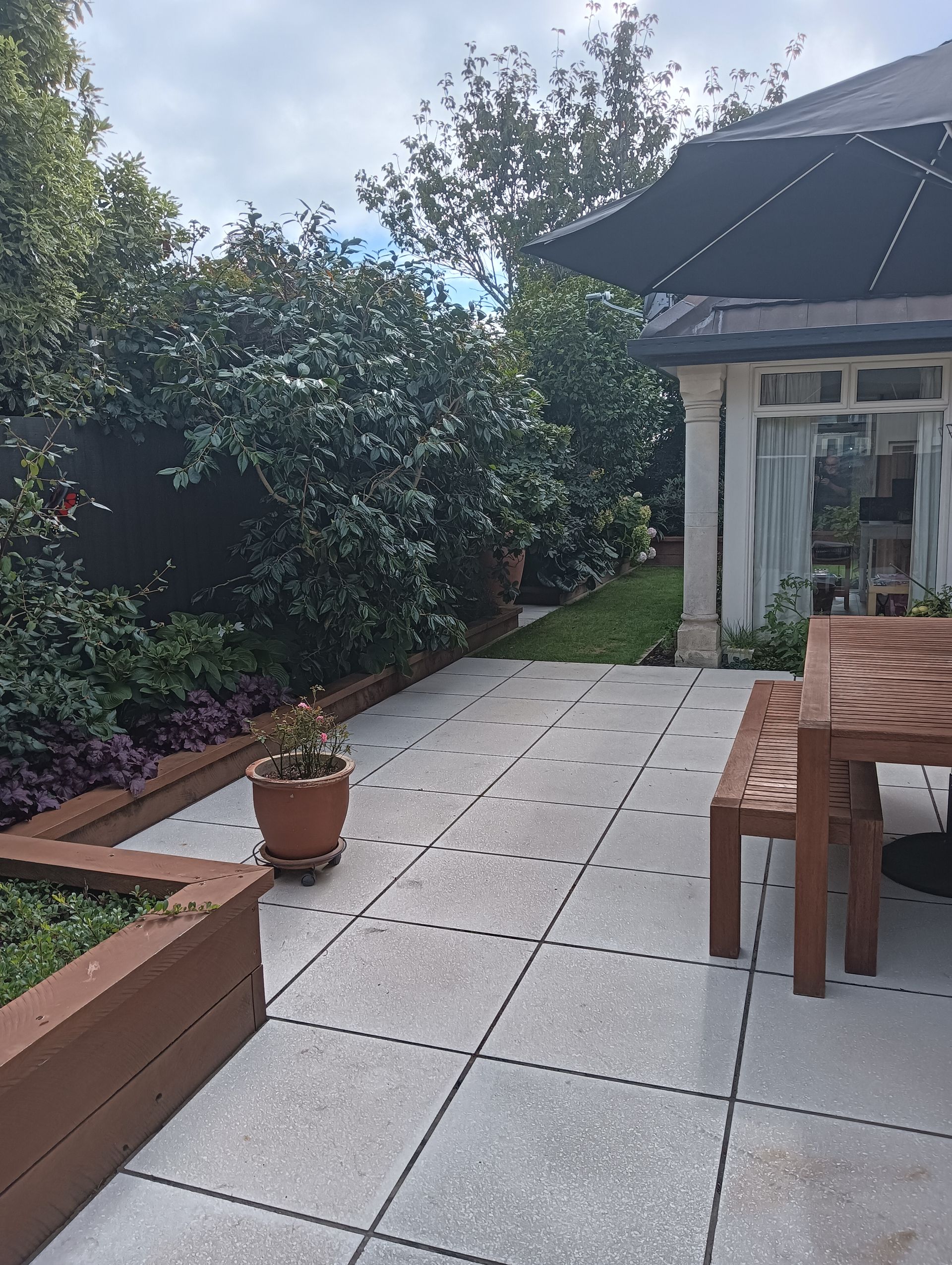 A patio with a table and chairs in front of a house