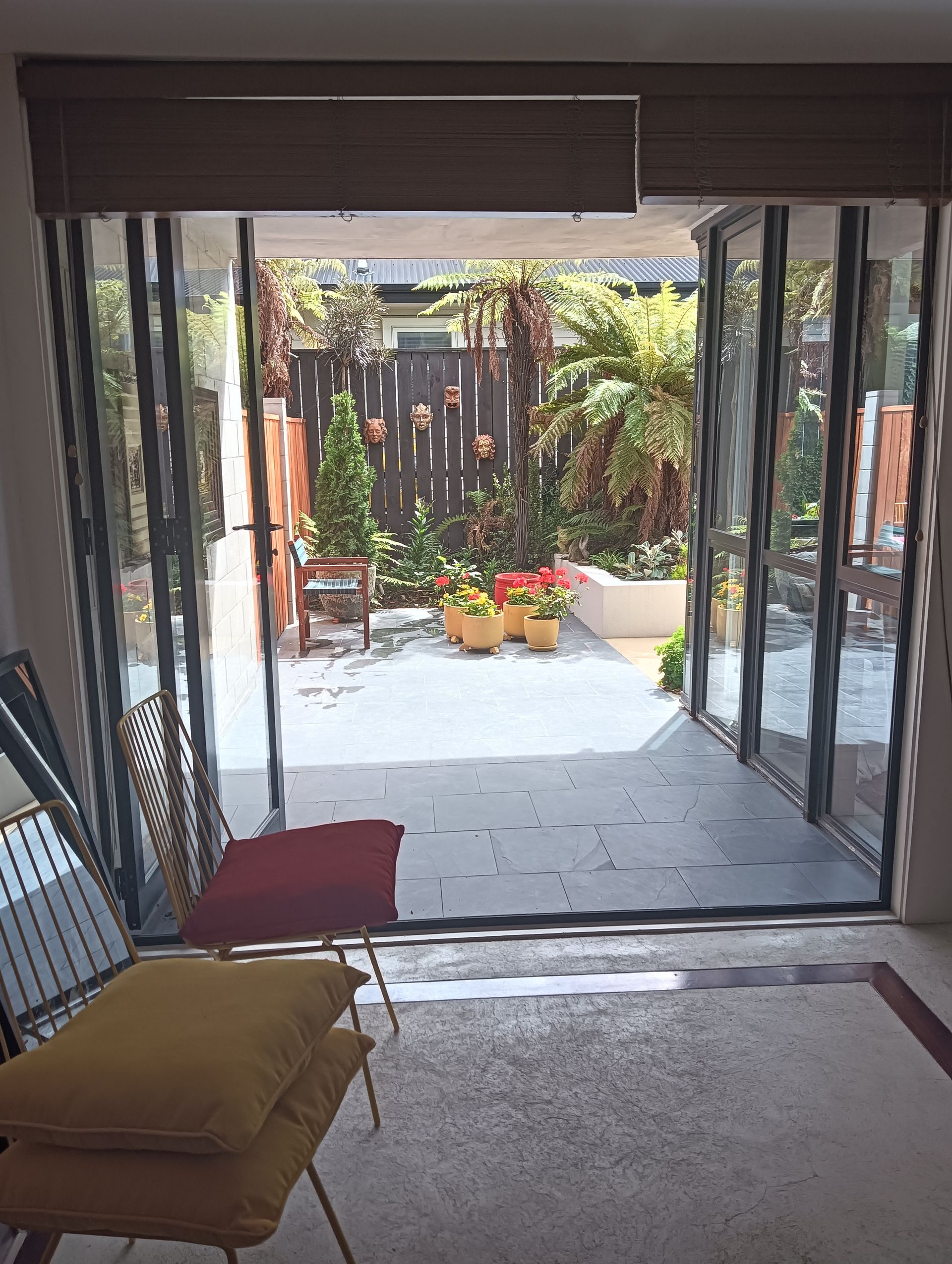 A living room with sliding glass doors leading to a garden