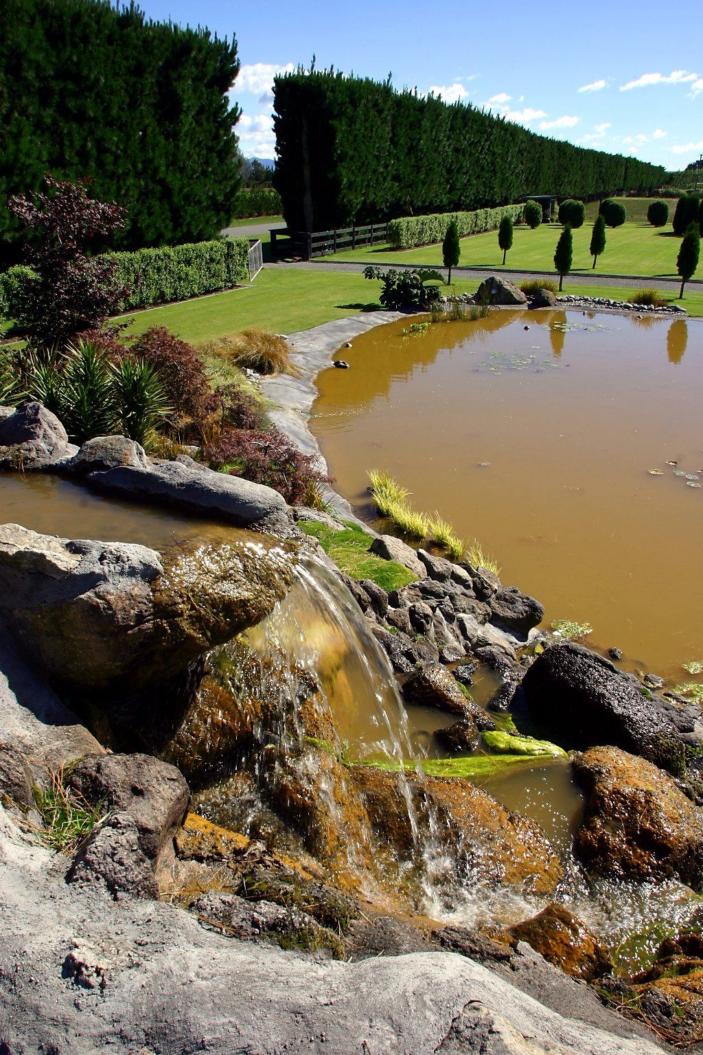 A pond with a waterfall in the middle of it